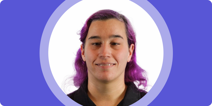 Banner image. Portrait of Caitlin W. a woman with long, wavy purple hair, wearing a black top, set inside a purple circular frame.